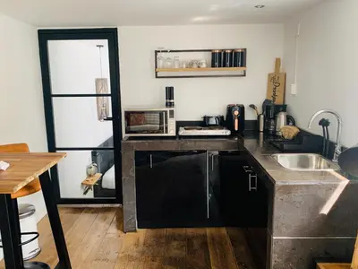 a kitchen with a counter top and a sink at Finch guesthouse in Zandvoort