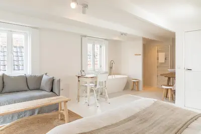a living room with a couch and a table and a tub at Luttik in Alkmaar