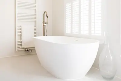 a white bath tub in a bathroom with a window at Luttik in Alkmaar