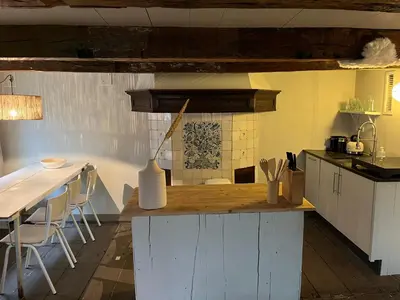 a kitchen with a counter and a table and a counter top at Luttik in Alkmaar
