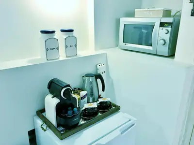 a kitchen with a coffee maker and a microwave at Amsterdam Home in Amsterdam