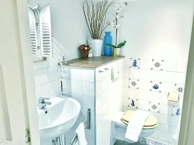 a white bathroom with a toilet and a sink at Amsterdam Home in Amsterdam