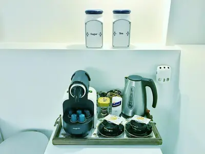 a shelf with a tea pot and a coffee maker at Amsterdam Home in Amsterdam