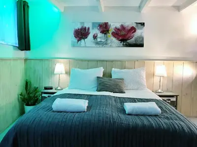 a bedroom with a large bed with two pillows on it at Amsterdam Home in Amsterdam