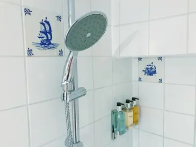 a shower with a shower head in a bathroom at Amsterdam Home in Amsterdam