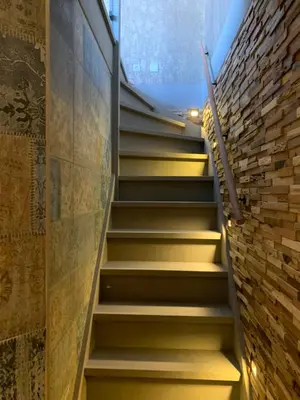 a staircase in a room with a brick wall at beach apartments in Zandvoort