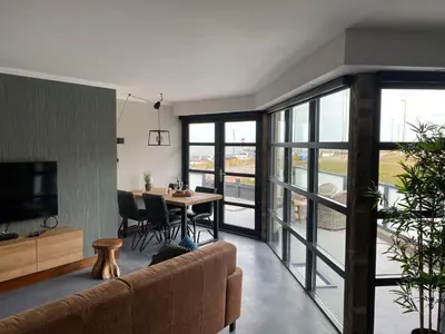 a living room with a couch and a table at beach apartments in Zandvoort