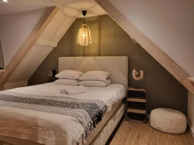 a bedroom with a bed in the attic at Tip! Noordwijk city center house in Noordwijk aan Zee
