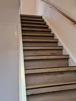a staircase in a house with wooden steps at Tip! Noordwijk city center house in Noordwijk aan Zee