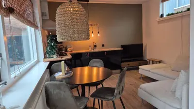 a living room with a table and chairs at Tip! Noordwijk city center house in Noordwijk aan Zee