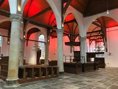 a large building with columns and red lighting at Bed en kerk monumentale 2 slaapkamer woning in Hoorn