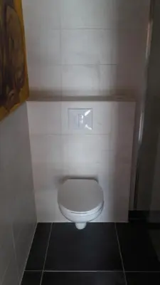 a bathroom with a white toilet in a stall at De indiaan in Noord-Scharwoude