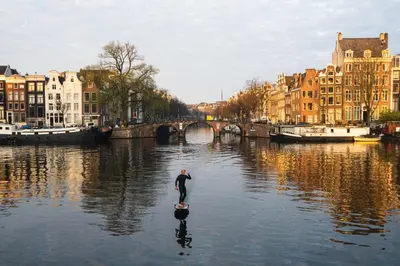 a man standing in the middle of a river at Motor Yacht Amstelle in Amsterdam