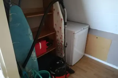 a small kitchen with a refrigerator and a table at Vakantiehuis Horsterwold in Zeewolde