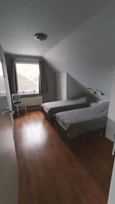 a bedroom with two beds and a window at Vakantiehuis Horsterwold in Zeewolde