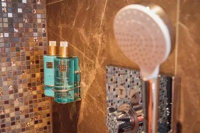a bathroom with a mirror and a tennis racket at Harbour Suites Boutique Hotel in Monnickendam