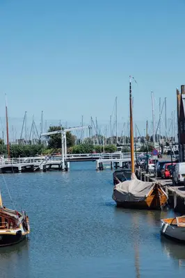 a group of boats docked in a harbor at Harbour Suites Boutique Hotel in Monnickendam