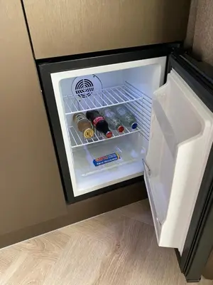 an open refrigerator filled with drinks and alcohol at Harbour Suites Boutique Hotel in Monnickendam