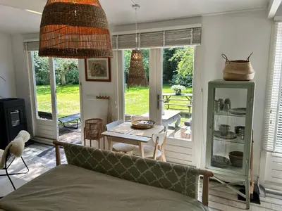 a living room with a couch and a table at Lodge 'De Groene Parel' in Schoorl