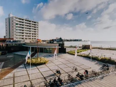 a group of bikes parked on a sidewalk near the beach at Keller Beach in Zandvoort