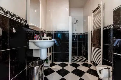 a bathroom with a sink and a shower at Keller Beach in Zandvoort