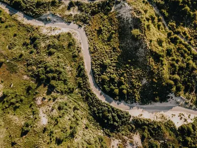 an aerial view of a river in a forest at Keller Beach in Zandvoort