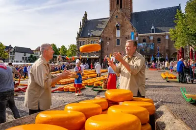 two men standing in front of a display of cheese at Uniek vakantiehuisje in rustige en groene omgeving in Nieuwe-Niedorp