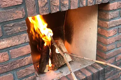 a brick oven with fire inside of it at Villa Klein Geluk in Egmond aan Zee
