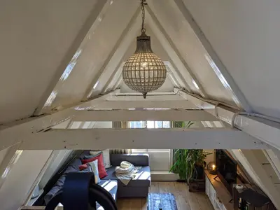 a chandelier hanging from the ceiling of a attic at StoreStay DamSquare in Amsterdam