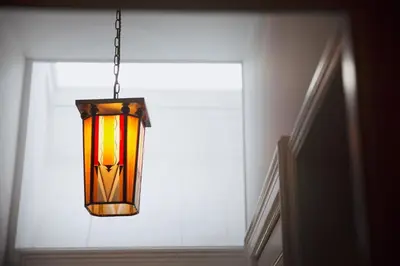 a chandelier hanging in front of a window at MUZE Hotel Utrecht in Utrecht