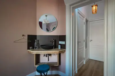 a bathroom with a sink and a mirror at MUZE Hotel Utrecht in Utrecht