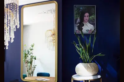 a room with a mirror and a vase with a plant at MUZE Hotel Utrecht in Utrecht