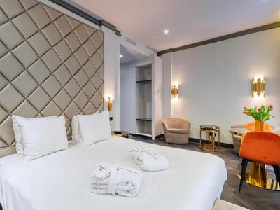 a bedroom with a white bed with two towels on it at Triple G Hotels in Amsterdam