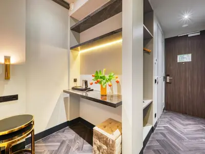 a hallway with a bar in a hotel room at Triple G Hotels in Amsterdam