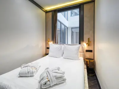 a bedroom with a bed with towels on it at Triple G Hotels in Amsterdam