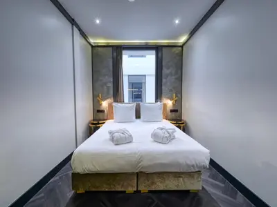 a bedroom with a bed with two towels on it at Triple G Hotels in Amsterdam