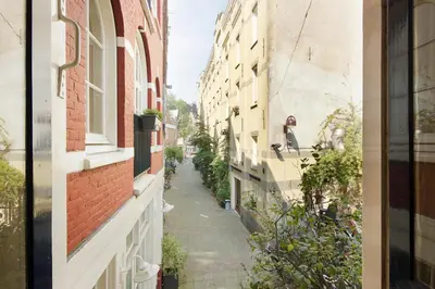 an alley between two buildings in a city at Green Alley Studio in Amsterdam