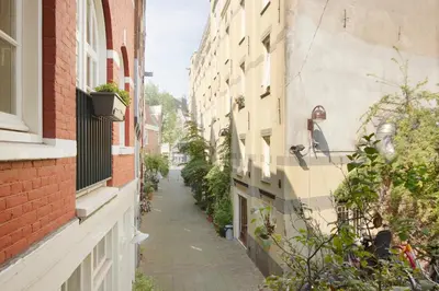 an alley between two buildings in a city at Green Alley Studio in Amsterdam