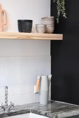 a kitchen counter with a sink and a shelf at In de bocht in Heiloo