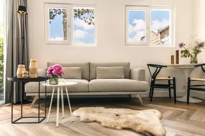 a living room with a couch and a table at The Pine Tree House in Zandvoort