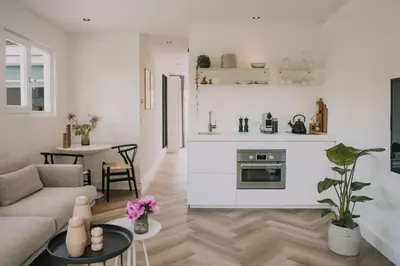 a living room with a couch and a table at The Pine Tree House in Zandvoort