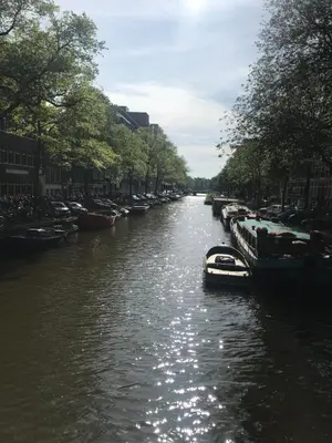 a river with boats parked on the sides of it at Six in Amsterdam