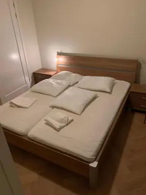 a bed with white sheets and pillows on it at Vakantiehuis Villa Zeewolde in Zeewolde
