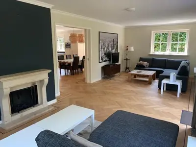 a living room with a couch and a fireplace at Vakantiehuis Villa Zeewolde in Zeewolde