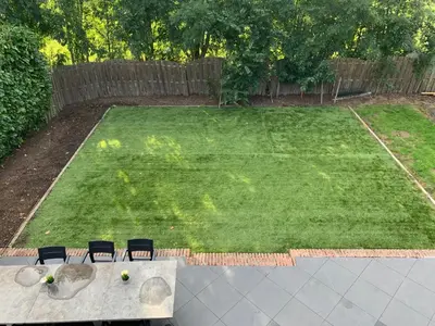 a lawn with chairs and a table in a yard at Vakantiehuis Villa Zeewolde in Zeewolde
