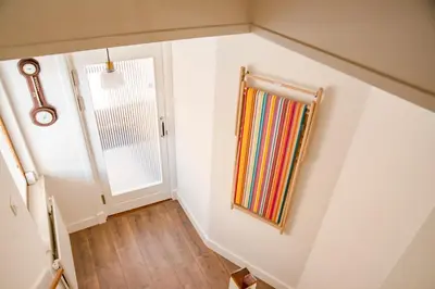 a room with a staircase with a mirror and a door at Emma's beach house in Katwijk aan Zee