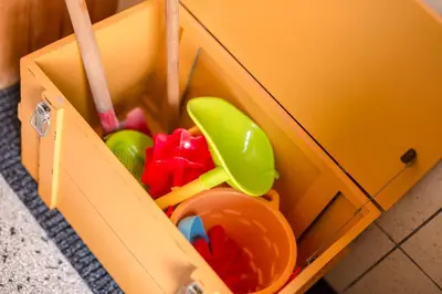 a yellow toy box with toys in it at Emma's beach house in Katwijk aan Zee
