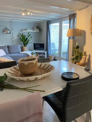 a living room with a table with a basket on it at Dromen aan het strand in Egmond aan Zee