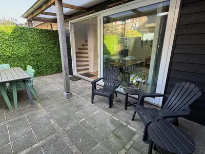 two chairs and a table on a patio at Beaufort in Egmond aan Zee