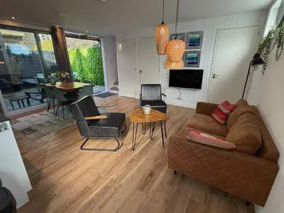 a living room with a couch and a table at Beaufort in Egmond aan Zee